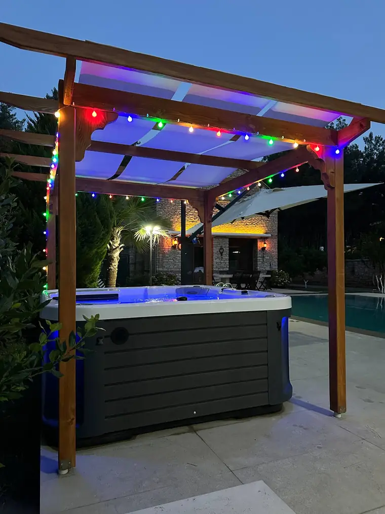 Renkli ışıklı pergola altında jakuzi